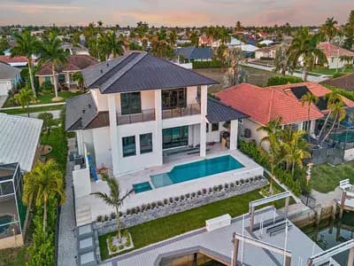 Aerial view of landscaped property with pool